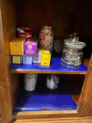 a shelf in a cabinet filled with food items at A casa di Simone in Rome