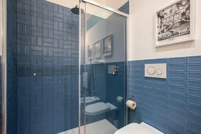 a bathroom with a toilet and a glass shower at Design Home - Vicino il centro in Rome