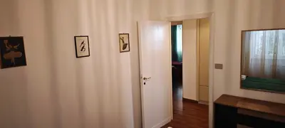 a hallway with a door and pictures on the wall at San Peter's Gates in Rome