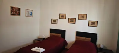 a bedroom with two beds and pictures on the wall at San Peter's Gates in Rome