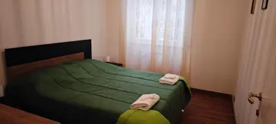 a bedroom with a green bed with two towels on it at San Peter's Gates in Rome