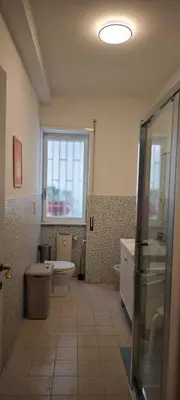 a bathroom with a tub and a toilet and a window at San Peter's Gates in Rome