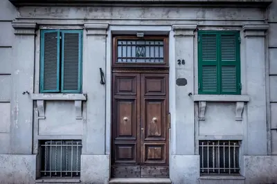a building with a wooden door and two windows at Aradam Luxury Heritage in Rome