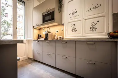 a kitchen with white cabinets and a microwave at Aradam Luxury Heritage in Rome