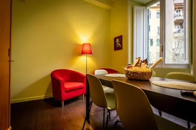 a dining room with a table and a red chair at Aradam Luxury Heritage in Rome