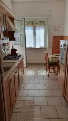 a kitchen with a table and a stove top oven at Attico Balduina in Rome