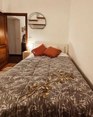 a bedroom with a large bed with red pillows at Obelisco Rhome in Rome