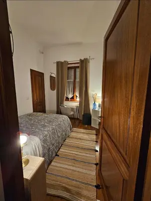 a small bedroom with a bed and a door at Obelisco Rhome in Rome