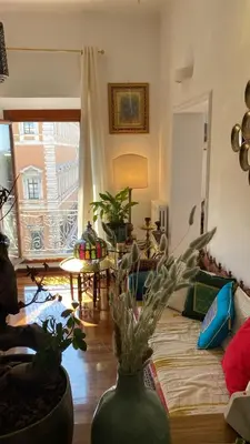a living room with a vase with a plant in it at Obelisco Rhome in Rome
