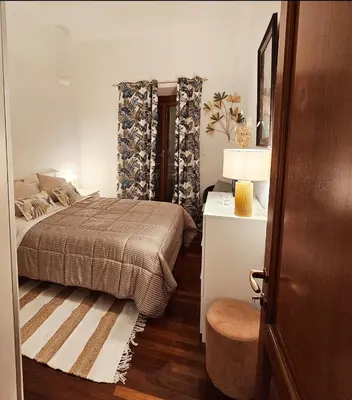 a bedroom with a bed and a table with a lamp at Obelisco Rhome in Rome