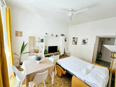 a bedroom with a bed and a table and chairs at Costantino Imperatore Apt in Rome