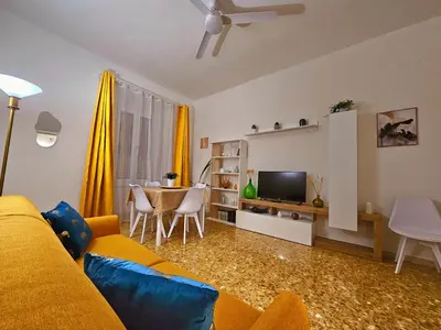 a living room with a yellow couch and a table at Costantino Imperatore Apt in Rome