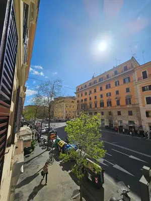 a person walking down a city street with buildings at Costantino Imperatore Apt in Rome