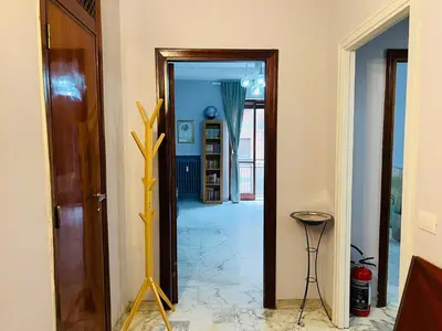 a room with a hallway with a door and a mirror at La Porta del Perugino - near the Vatican in Rome