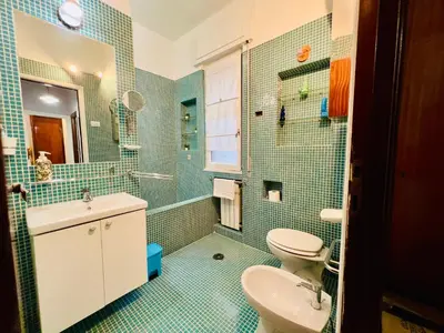 a bathroom with a sink and a toilet and a mirror at La Porta del Perugino - near the Vatican in Rome
