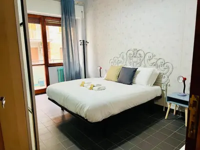 a bedroom with a white bed with a teddy bear on it at La Porta del Perugino - near the Vatican in Rome