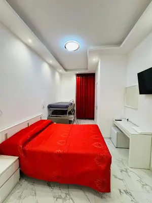 a bedroom with a red bed and a desk at Casa Roma in Rome