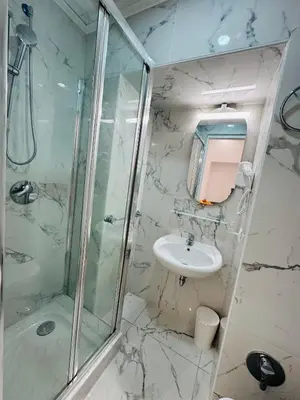a white bathroom with a shower and a sink at Casa Roma in Rome