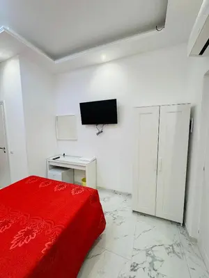 a bedroom with a red bed and a tv on the wall at Casa Roma in Rome