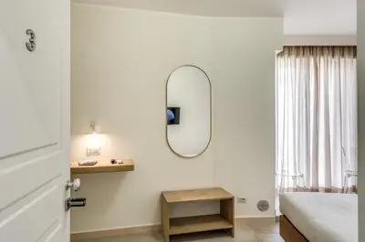 a bedroom with a bed and a mirror on the wall at Boezio 6 Rooms by Roman Dreams in Rome