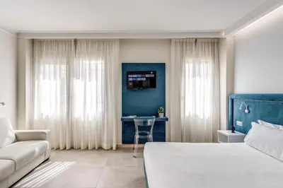 a bedroom with a bed and a couch and a table at Boezio 6 Rooms by Roman Dreams in Rome