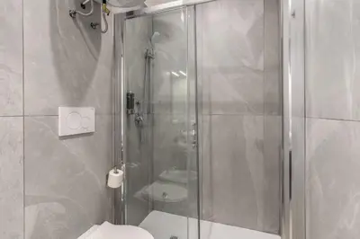 a bathroom with a shower and a toilet at Boezio 6 Rooms by Roman Dreams in Rome