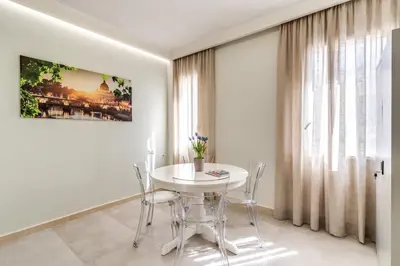 a white dining room with a white table and chairs at Boezio 6 Rooms by Roman Dreams in Rome