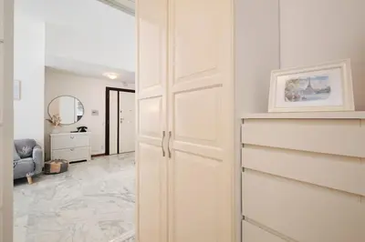 a hallway with white cabinets and a living room at Vaticano - Giubileo - A 2 passi da San Pietro by Hôtea in Rome