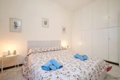a bedroom with a bed with two blue towels on it at Vaticano - Giubileo - A 2 passi da San Pietro by Hôtea in Rome