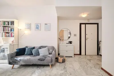 a living room with a couch and a mirror at Vaticano - Giubileo - A 2 passi da San Pietro by Hôtea in Rome