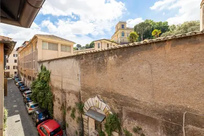 a row of cars parked next to a wall at Panieri Apt - Homkeey Apartments in Rome