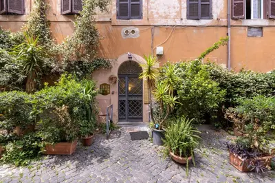a building with a bunch of plants in front of a door at Panieri Apt - Homkeey Apartments in Rome