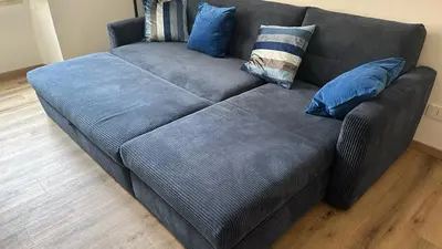 a gray couch with blue pillows in a living room at RM 191 - La Tua Casa lontano da Casa in Rome