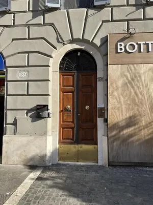 a building with a wooden door on the side of it at RM 191 - La Tua Casa lontano da Casa in Rome