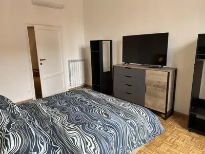 a bedroom with a bed and a flat screen tv at RM 191 - La Tua Casa lontano da Casa in Rome