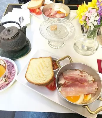 a table with a plate of food and a pan of eggs and bread at Piazza di Spagna Suite de Charme in Rome