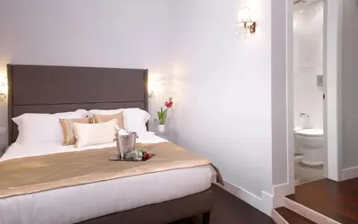 a bedroom with a large bed and a toilet at Piazza di Spagna Suite de Charme in Rome