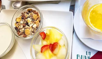 two bowls of food with fruit and a bowl of cereal at Piazza di Spagna Suite de Charme in Rome