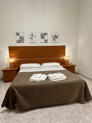 a bedroom with a bed with two towels on it at Alloggio Turistico Eli in Rome