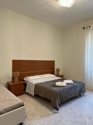 a bedroom with a bed with two towels on it at Alloggio Turistico Eli in Rome