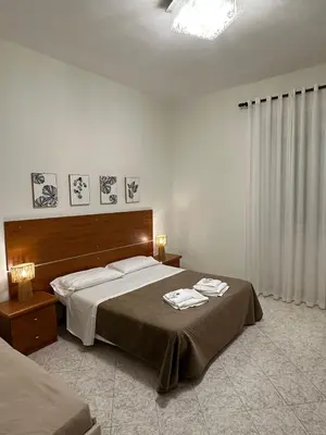 a bedroom with a large bed with two towels on it at Alloggio Turistico Eli in Rome