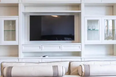a living room with a large tv and a couch at VIVILO COLLECTION - Magna Grecia 29 View Apartment in Rome
