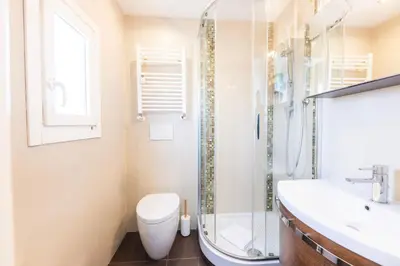 a bathroom with a shower and a toilet and a sink at VIVILO COLLECTION - Magna Grecia 29 View Apartment in Rome