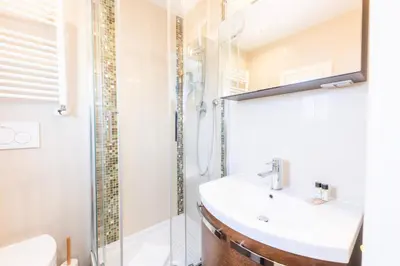 a bathroom with a sink and a shower at VIVILO COLLECTION - Magna Grecia 29 View Apartment in Rome