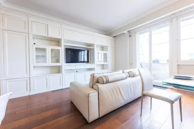 a living room with a couch and a tv at VIVILO COLLECTION - Magna Grecia 29 View Apartment in Rome