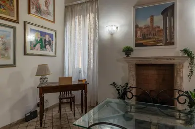 a living room with a glass table and a fireplace at GuestHost - Apartment Near Piazza Navona in Rome