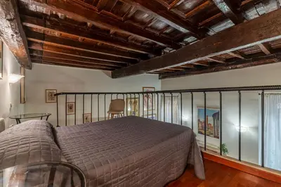 a bedroom with a large bed and a balcony at GuestHost - Apartment Near Piazza Navona in Rome