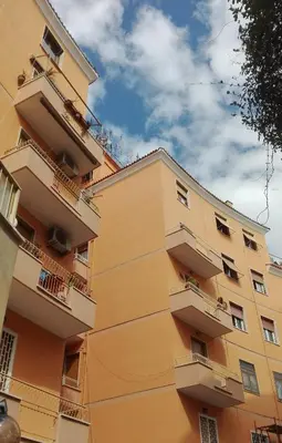 a yellow building with balconies on the side of it at B&B La Casa di Gabry in Rome