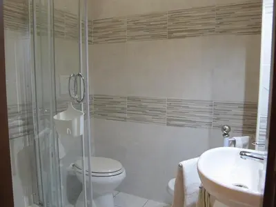 a bathroom with a shower and a toilet and a sink at B&B La Casa di Gabry in Rome
