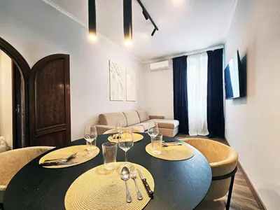 a dining room with a table with wine glasses on it at Gallo 55 Stylish & Modern Stay Near the Vatican in Rome
